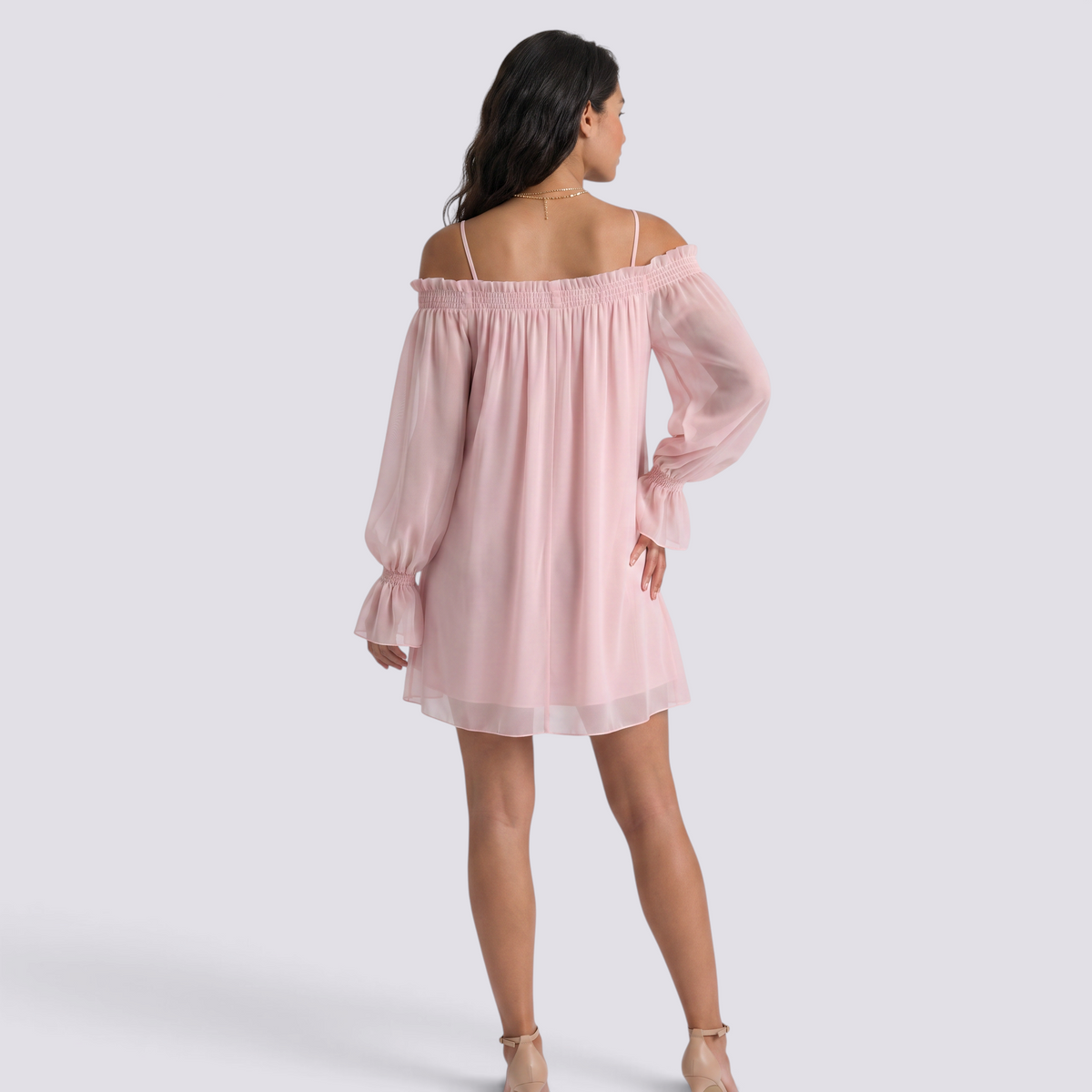Essyro light pink mini dress with bardot neckline, sheer long sleeves, and flowy silhouette worn by a model
