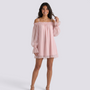 Essyro light pink mini dress with bardot neckline and sheer long sleeves worn by a smiling model