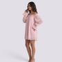 Essyro light pink mini dress with bardot neckline and sheer long sleeves worn by a model on a white background