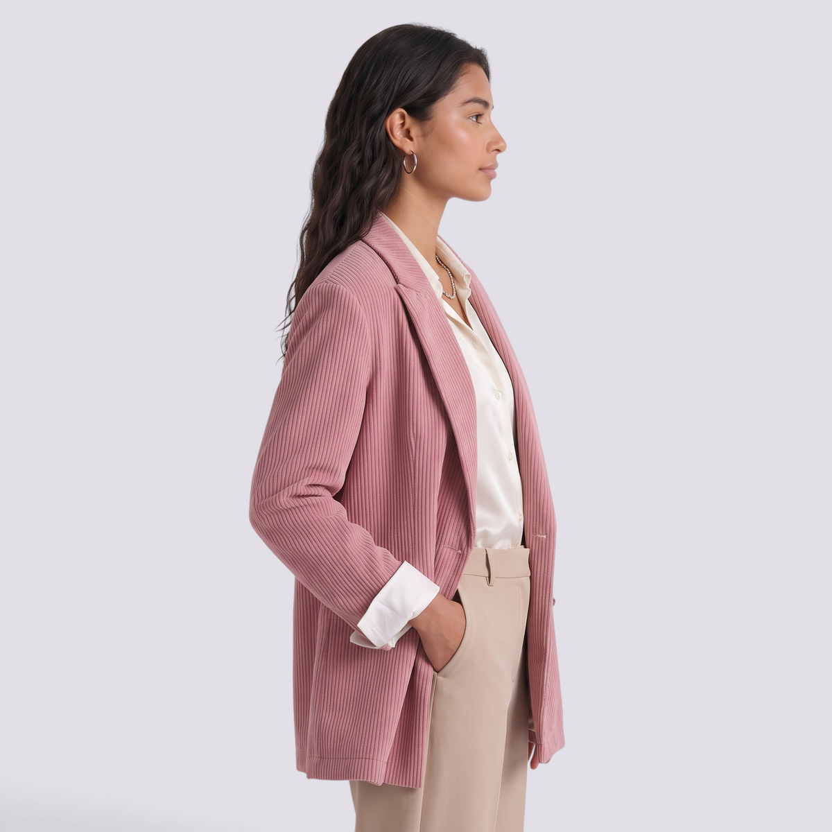 Essyro pink corduroy oversized double-breasted blazer worn by a model in profile view with beige trousers
