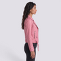 Essyro pink faux leather biker jacket worn by a woman in profile view, featuring a belted waist and silver zips.