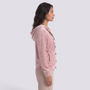 Essyro velvet hooded cardigan in soft pink with front buttons and pockets, worn by a model in a side profile view.