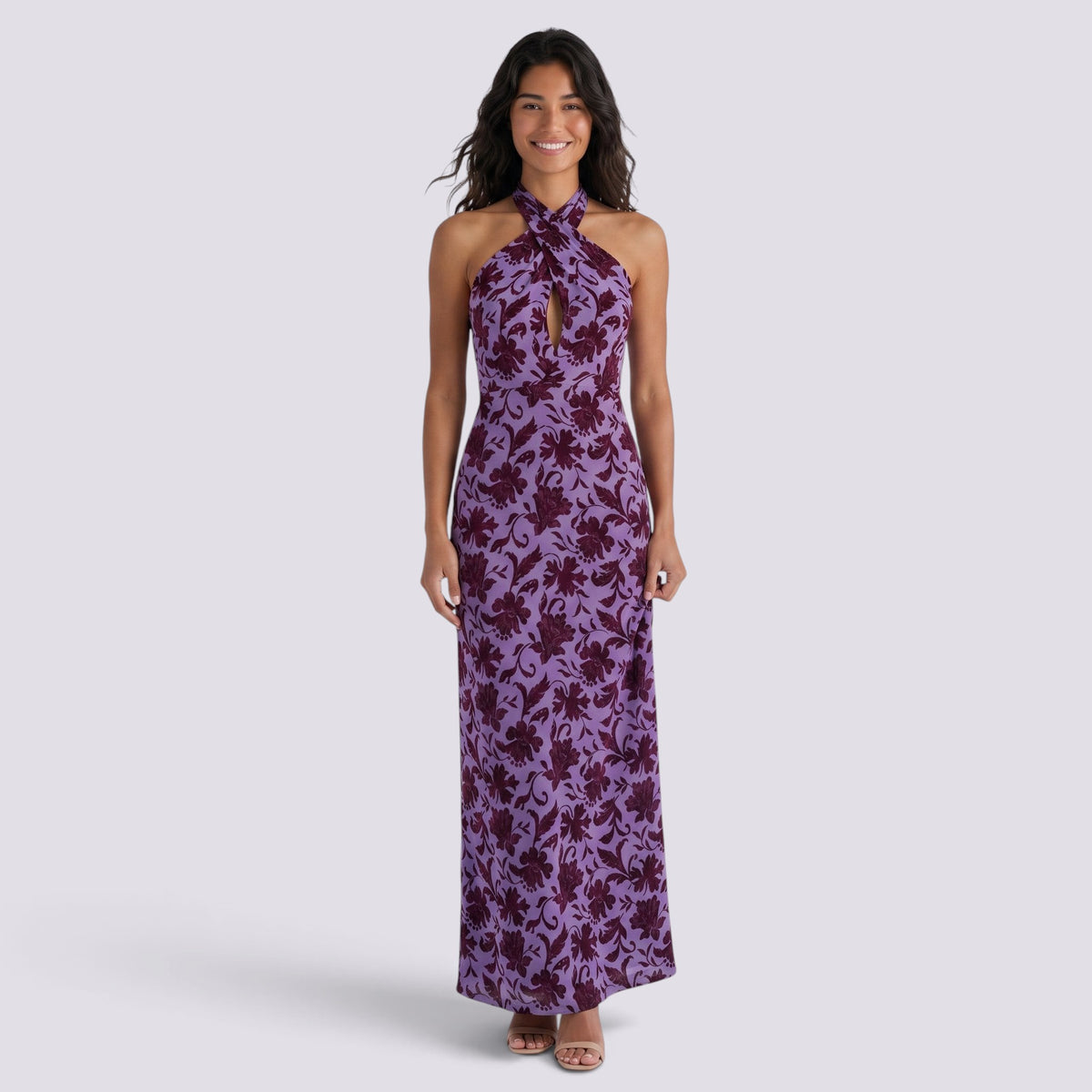 Essyro purple floral maxi dress with a halter neckline, front knot detail, and side slit worn by a smiling model.