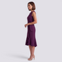Essyro sleeveless purple midi dress with a round neckline and waist tie detail worn by a model in profile view
