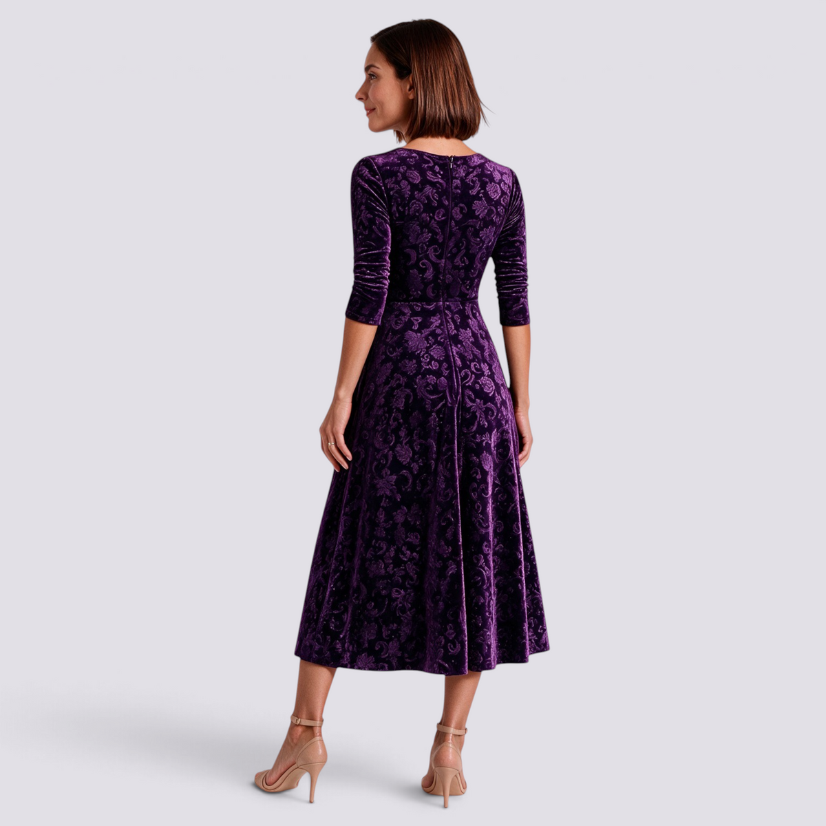 Essyro purple velvet midi dress with floral jacquard pattern, long sleeves, and A-line skirt, back view on model.