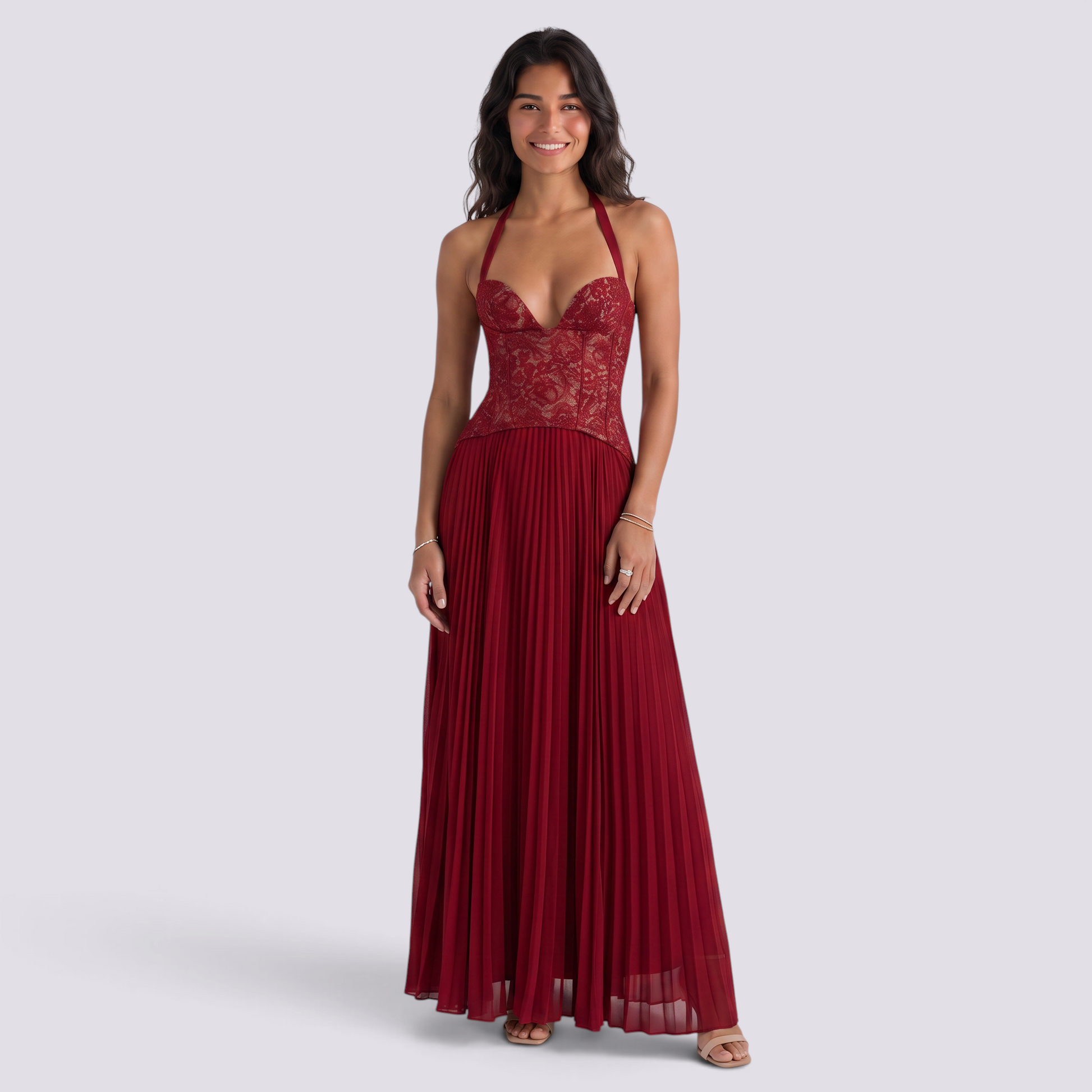 Essyro red floor-length halter gown with a lace corset bodice and pleated skirt worn by a smiling model