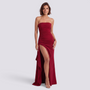 Essyro red strapless floor-length evening gown with a high side slit worn by a model on a light grey background