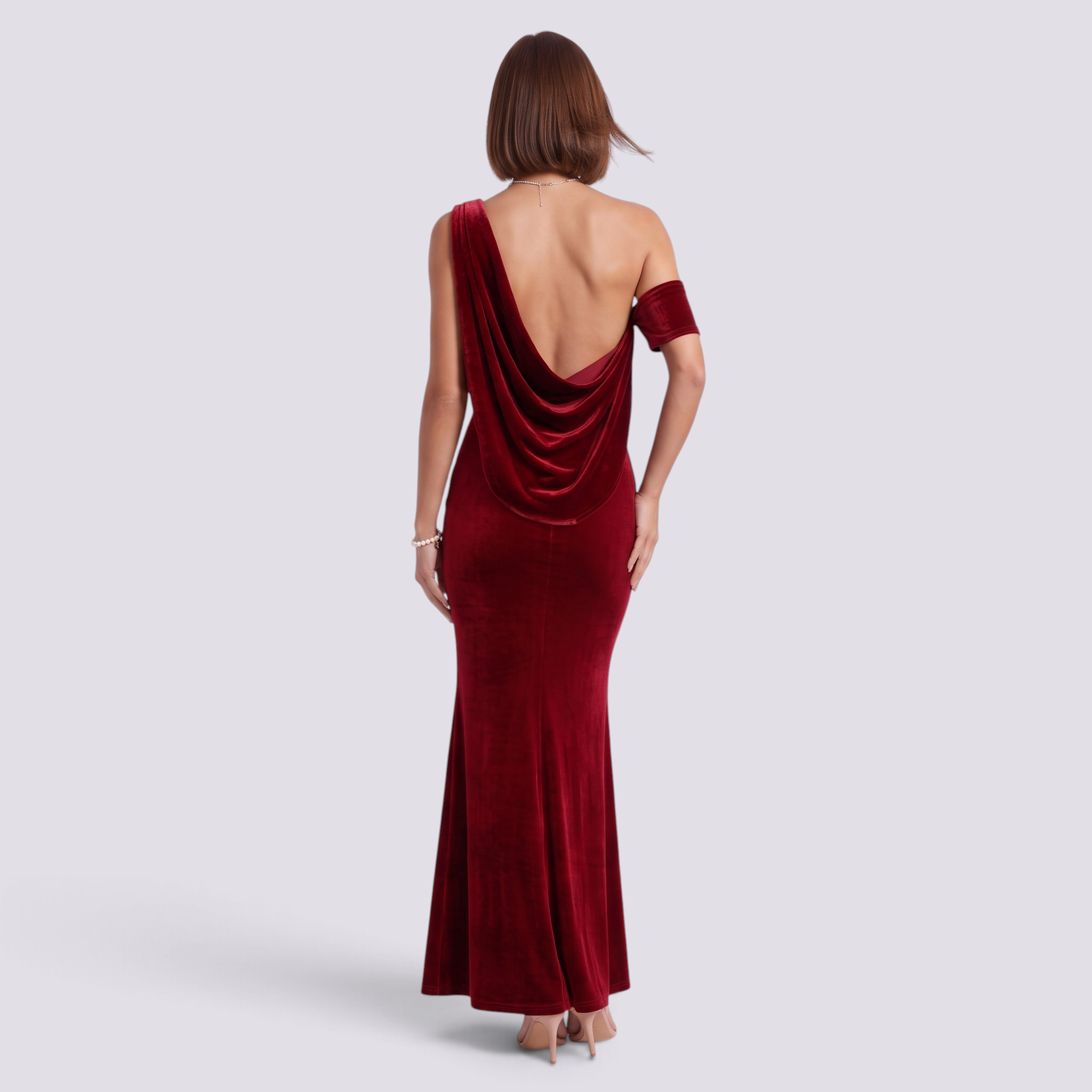 Essyro red velvet mermaid gown with an asymmetrical one-shoulder neckline and a dramatic draped back detail.