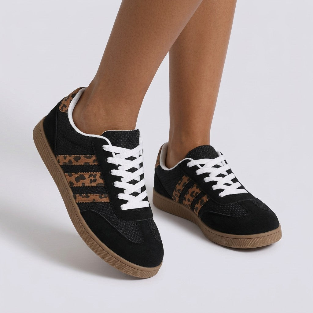 Essyro women's retro low-top sneakers in black with leopard print side stripes, suede panels, and gum rubber soles.