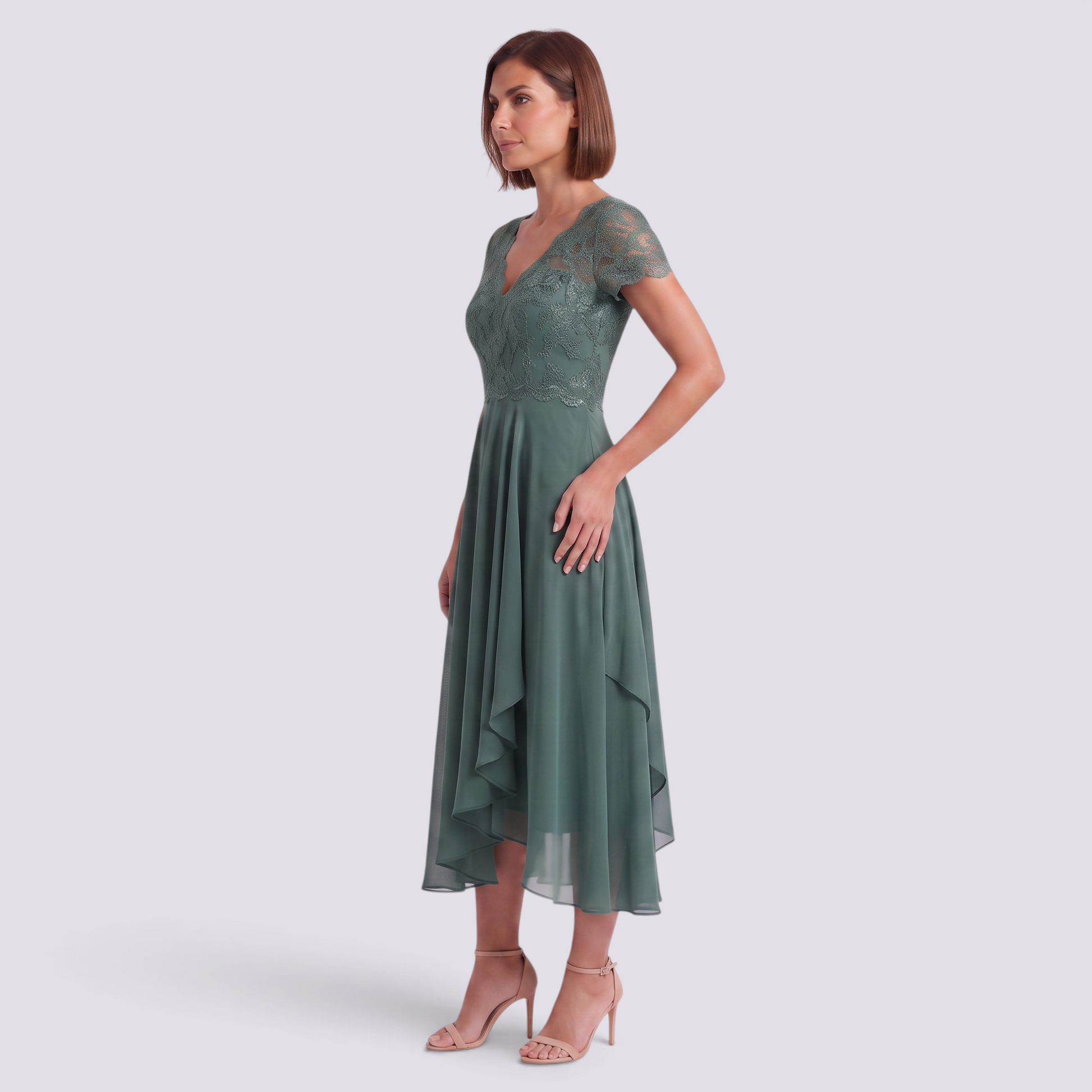 Essyro sage green midi dress with V-neck, delicate lace bodice, and flowing asymmetrical skirt on a model