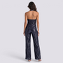 Essyro back view of a dark sequin halter neck jumpsuit with wide legs and an open back on a model