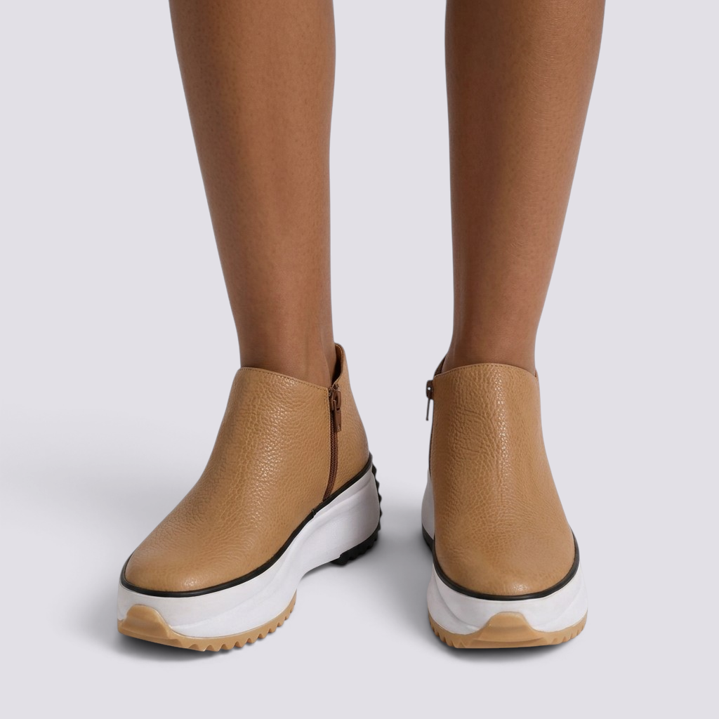Essyro tan leather ankle boots with a chunky white platform sole and side zipper, worn on a model.