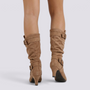 Essyro slouch boots in tan faux suede with mid-curved heels and decorative side buckles, back view