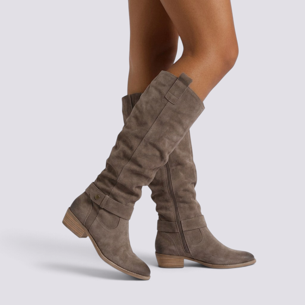 Essyro taupe suede slouch knee-high boots with low block heel, round toe, and decorative ankle strap with metal rivet.