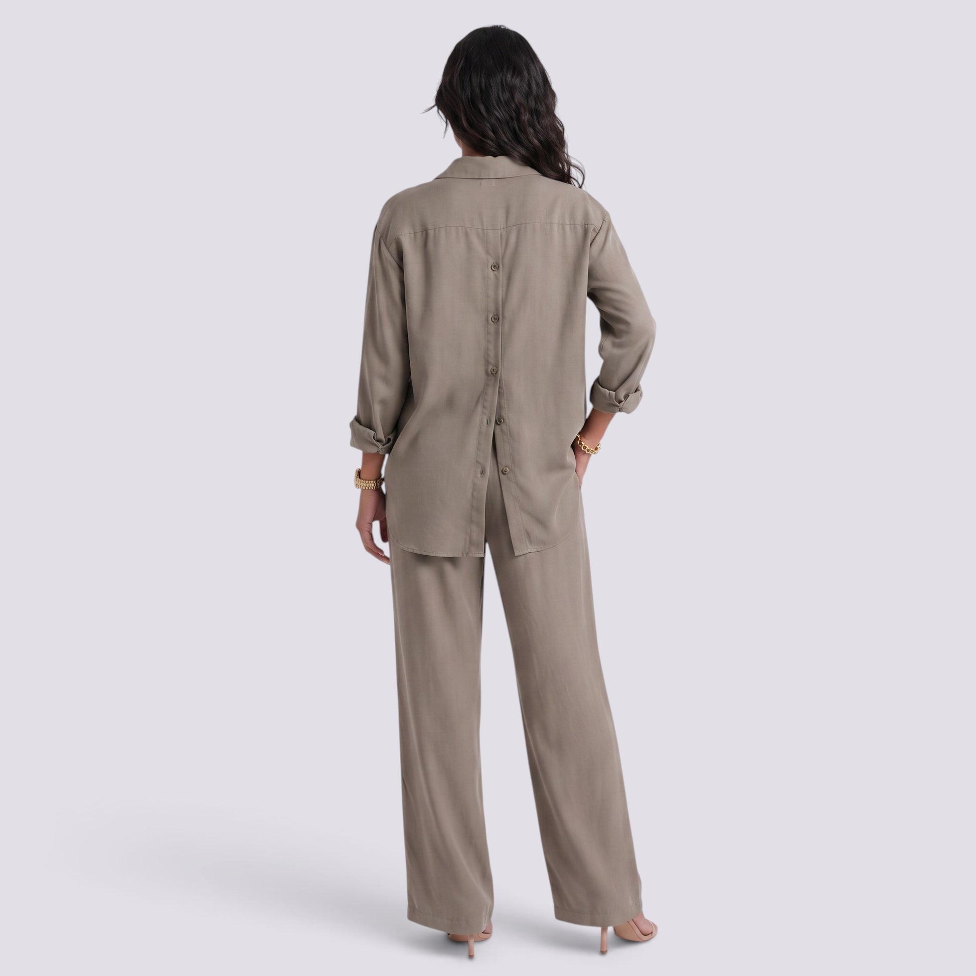 Essyro two-piece set featuring a taupe long-sleeve button-back shirt and matching wide-leg trousers on a model