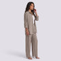 Essyro two-piece set featuring a taupe long-sleeve button-down shirt and matching wide-leg trousers on a model.