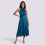 Essyro teal midi dress with halter neck and geometric disc skirt worn by a model on a plain background