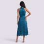 Essyro teal satin midi dress with a halter neck and geometric disc skirt, shown from the back on a model.