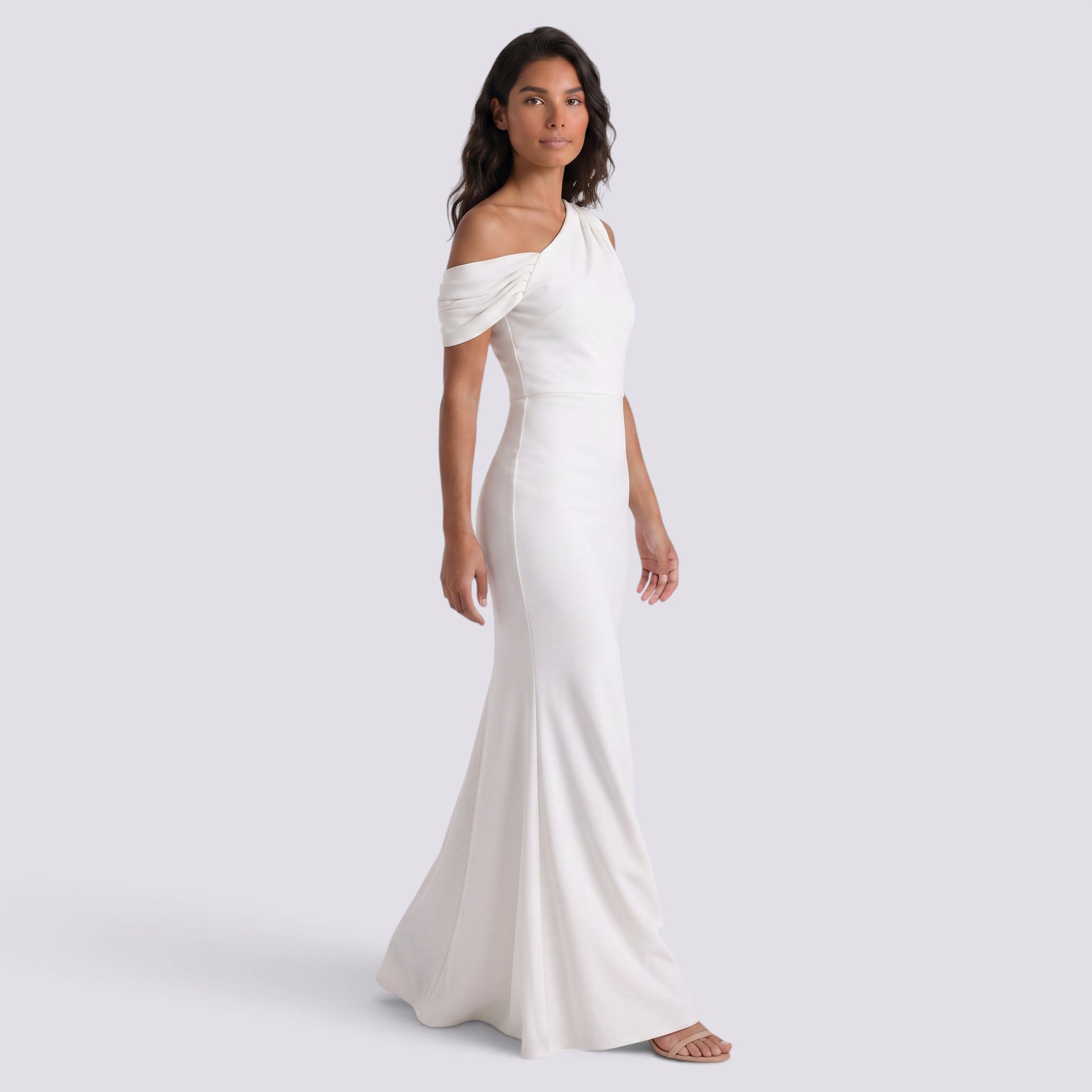 Essyro white floor-length mermaid gown with an asymmetric one-shoulder neckline and draped sleeve detail