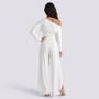 Essyro white one-shoulder jumpsuit with long draped sleeve and wide-leg trousers, back view on a model.