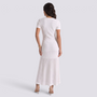 Essyro white ribbed knit maxi dress with short sleeves and flared hem seen from the back on a model