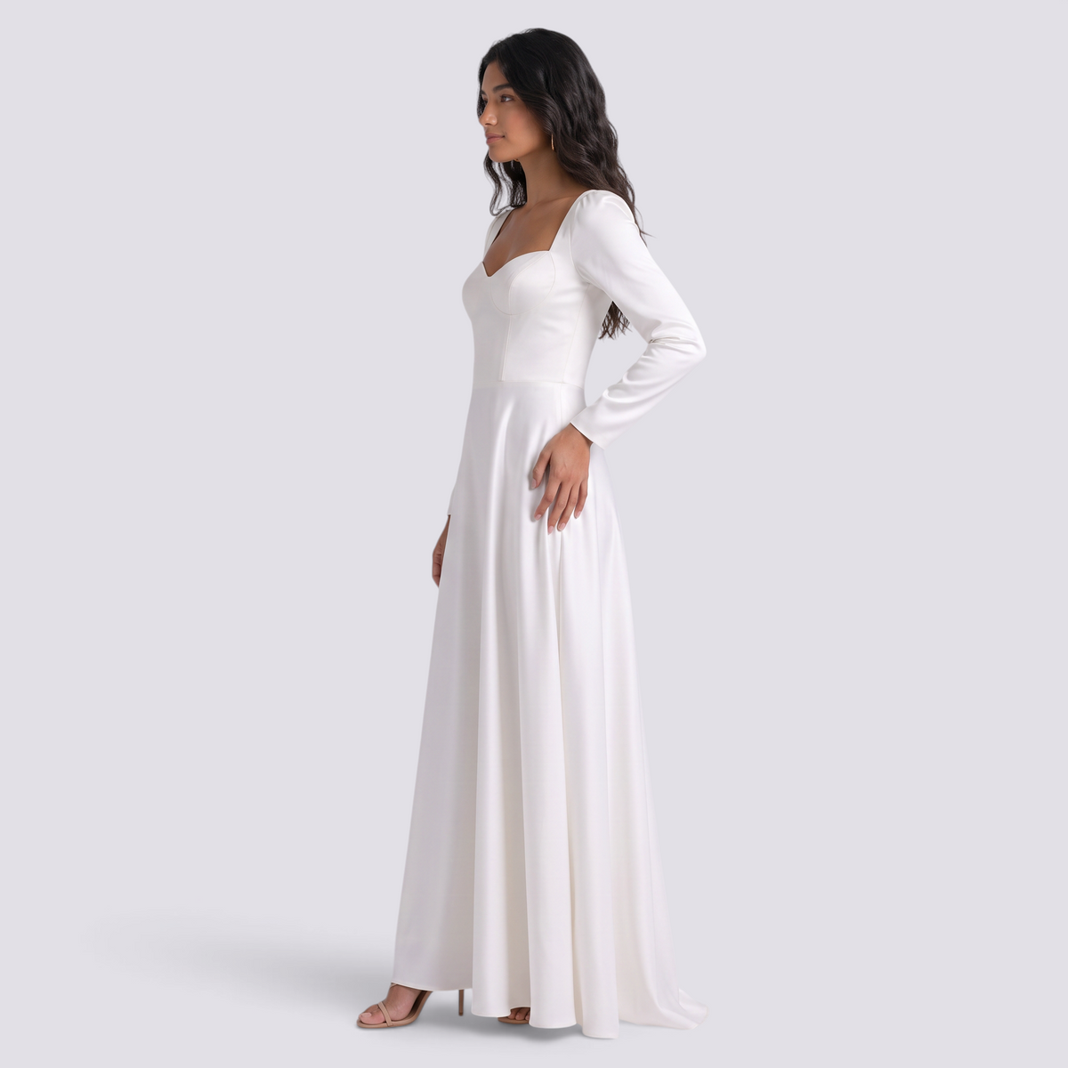 Essyro white A-line wedding dress with square neckline and long sleeves worn by a model in a side profile view