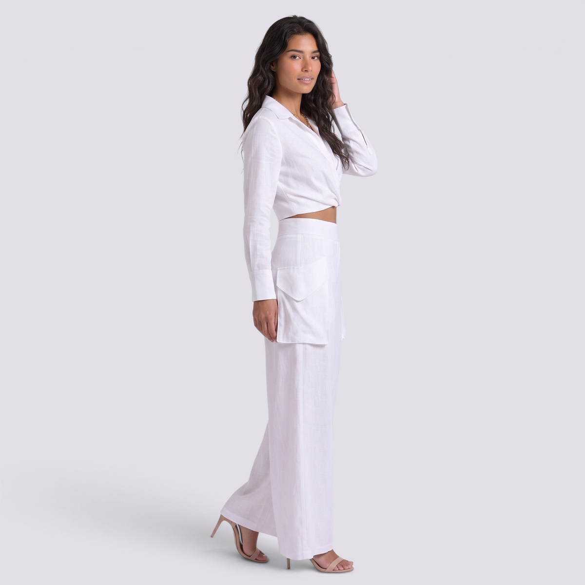 Essyro white two-piece set with long-sleeve wrap top and high-waisted palazzo pants with pockets on a model