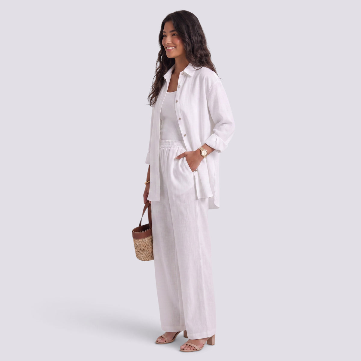 Essyro white two-piece set featuring a loose long-sleeve shirt and wide-leg trousers on a smiling woman