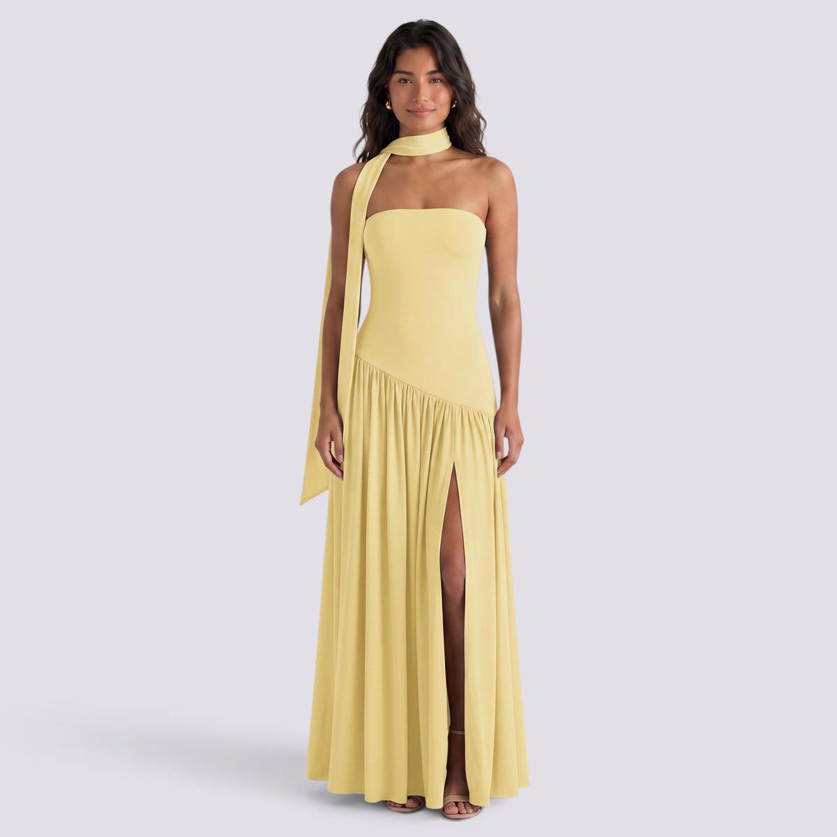 Essyro yellow floor-length party dress with halter neck, strapless bodice, and draped asymmetric skirt with slit.