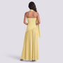 Essyro yellow floor-length halter neck evening dress with an asymmetrical draped skirt and open back design.