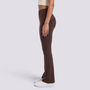 Mujer con leggings acampanados con bolsillos en marrón chocolate, vista lateral