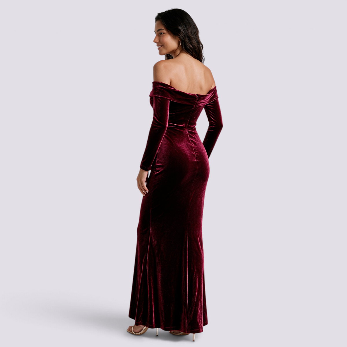 Essyro burgundy velvet mermaid evening gown with long sleeves and off-the-shoulder Bardot neckline on a model
