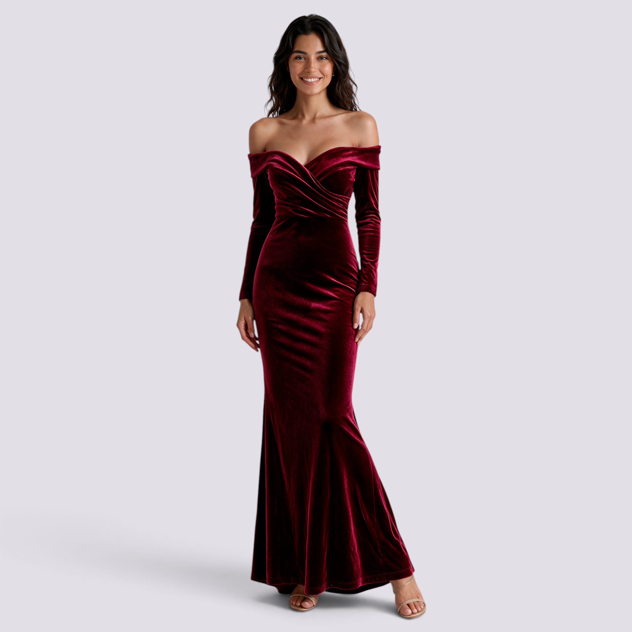 Essyro burgundy velvet mermaid evening gown with Bardot neckline and long sleeves worn by a smiling model