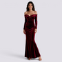 Essyro burgundy velvet mermaid evening gown with Bardot neckline and long sleeves worn by a smiling model